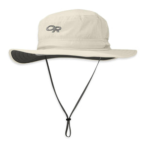 Cream sun hat by Outdoor Research with an 'OR' logo, wide brim with a dark underside, and adjustable chin strap.