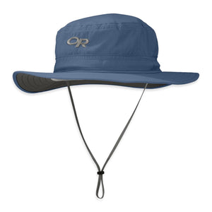 Blue sun hat with a wide brim by Outdoor Research, featuring an "OR" logo, dark grey underbrim, and an adjustable chin strap.