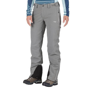 Women's grey pants by Outdoor Research with black lower leg panels and side zippers, worn with hiking boots.