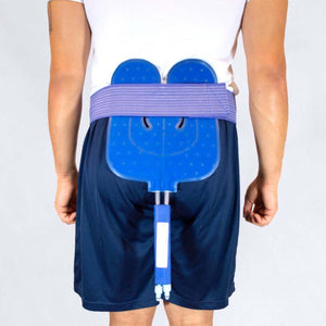 Blue U-shaped cold therapy pad and purple elastic belt by Polar Products, with a rigid blue component, worn on a person's lower back.