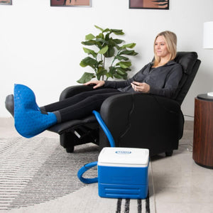 Blue foot and ankle cold therapy system by Polar Products, with a textured wrap on a foot and a blue and white cooling reservoir.