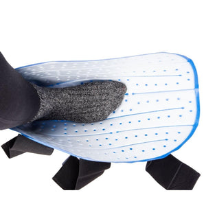 White and blue perforated Foot and Ankle Cold Therapy System by Polar Products, with a grey socked foot inside and black straps, seen from above.