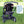 Back view of a black toddler stroller seat by Polar Products featuring grey adjustable straps in a stroller frame on green grass.