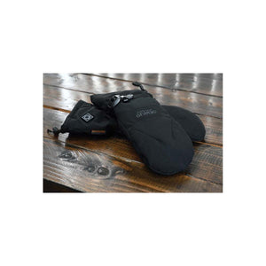 Black heated mittens by Seirus, featuring 'SEIRUS HEATTouch' text, a buckle, and a control button, resting on a wooden table.