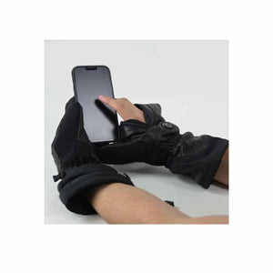 Women's black heated Magne Mittens by Seirus, worn while using a smartphone with bare fingers.
