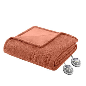 Terracotta twin heated blanket by Serta, folded showing its plush texture and two attached controllers.