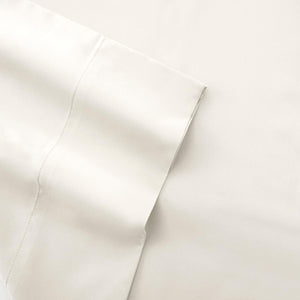 Off-white cotton percale sheet by Shavel, showing a wide folded hem with double-line stitching.
