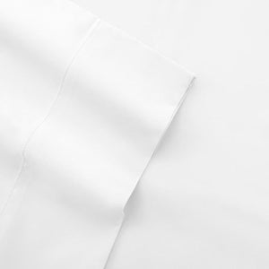 White cotton sateen sheet by Shavel, with a folded corner and decorative hemstitch.