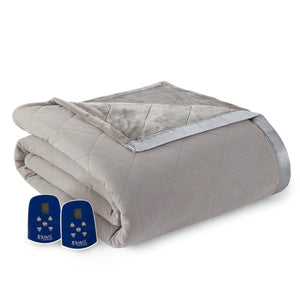 Grey electric heated ultra velvet blanket by Shavel with a quilted diamond pattern, satin trim, and two blue digital controllers.
