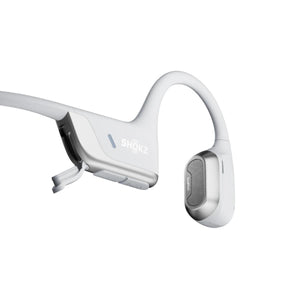 White open-ear bone conduction headphone by Shokz, with silver accents, visible speaker grille, and SHOKZ logo.