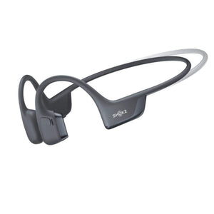 Dark gray bone conduction headphone by Shokz, with an ear hook design, shown from a side view.