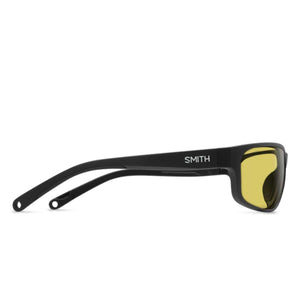 Matte black sunglasses with low light yellow lenses by Smith Optics, shown from a side view with the brand name on the temple.