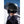 Dark green ski helmet by Smith Optics with a yellow Mips logo and brown goggle strap, worn from the back in a snowy mountain landscape.