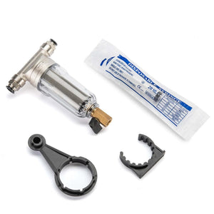 Clear plastic filter component by The Patio Misting System with silver fittings, a brass drain valve, and black plastic wrench and clamp.