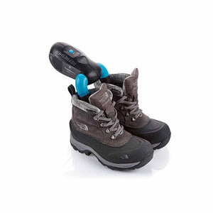 Black shoe refresher device by Therm-ic with blue tips, inserted into brown and black hiking boots.