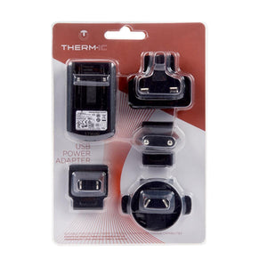Black USB power adapter with multiple international plugs by Therm-ic, packaged in a clear blister pack on a red card.