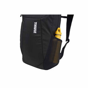 Black laptop backpack by Thule, cropped side view showing a yellow water bottle in a mesh side pocket.