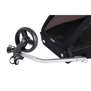 Black 2-Seat Bike Trailer by Thule, shown in a side view with a front wheel attachment and aluminum tow bar.