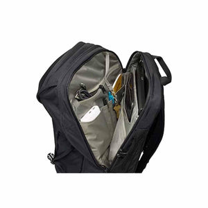 A black 30L laptop backpack by Thule, open to reveal multiple light grey interior pockets holding a power bank, keys, and laptop.