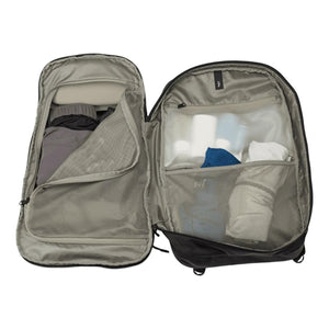 Black 30L laptop backpack by Thule, open to reveal two main compartments with clothes and toiletries in mesh and clear pockets.