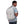Light grey backpack by Thule worn by a man in a vibrant patterned shirt, with a visible slanted front pocket.
