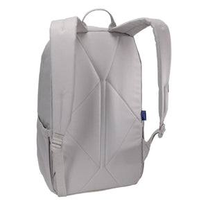 Light grey backpack by Thule, back view, with padded geometric panel, adjustable straps, and blue logo tag.