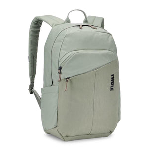 Sage green 23L backpack by Thule with an angled front pocket, padded shoulder strap, and side logo.