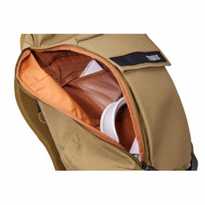 Tan laptop backpack by Thule, open to reveal an orange lining, mesh pockets, and a white item inside.