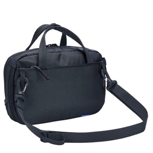 Dark gray crossbody bag by Thule with top handles, a zippered front pocket, and an adjustable shoulder strap shown at an angle.