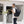 Black 26L travel backpack by Thule, worn by a smiling man walking past a coffee shop.
