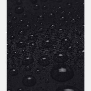 Black waterproof jacket by Under Armour with water droplets beading on the fabric surface.