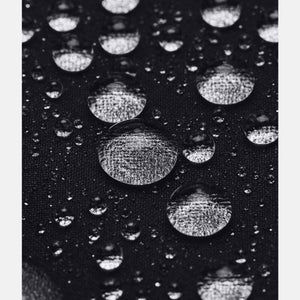 Black water-repellent fabric by Under Armour covered in clear water droplets, macro view.