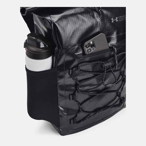 Black Summit Small Backpack by Under Armour, with a side water bottle pocket and front bungee lacing, holding a phone.