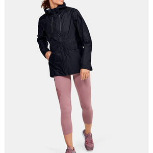 Black Cloudstrike Shell Jacket by Under Armour, hooded with a drawstring waist and reflective strips, worn over pink capri leggings.