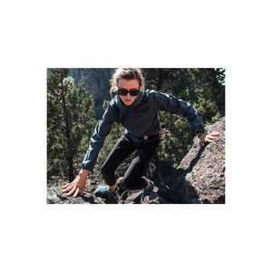Dark grey women's jacket by Under Armour, worn by a woman climbing rocks with black pants and sunglasses.