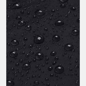 Black jacket by Under Armour, a close-up showing water droplets beading on the stormproof fabric.