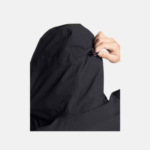 Black jacket by Under Armour, with a hand adjusting the hood drawstring toggle.