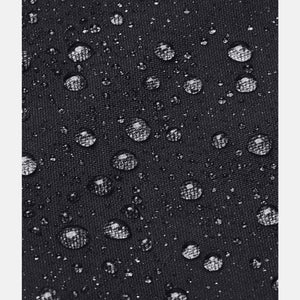 Black rain jacket by Under Armour, a close-up of water beading on the textured waterproof fabric.