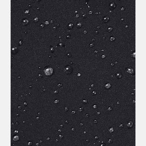 Black softshell jacket by Under Armour, with water droplets beading on its water-resistant fabric.