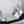 Black Full Body Bio-PEMF Mat by UTK Technology on a grey couch, with an elderly woman relaxing and visible blue circular patterns.
