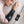 Black arm heating therapy pad by UTK Technology, worn by a woman and connected to a digital controller.