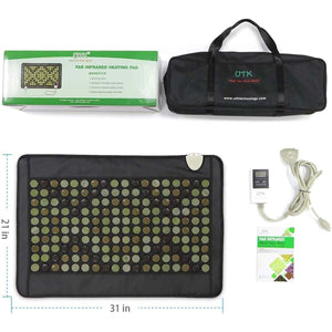 Black infrared heating pad by UTK Technology with visible jade, tourmaline, and magnet stones, measuring 21x31 inches, displayed with its carrying bag, digital controller, power cord, and retail box.