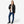 Black bomber jacket by Venture Heat with visible orange lining and logo, worn open over a white tee, jeans, and boots.