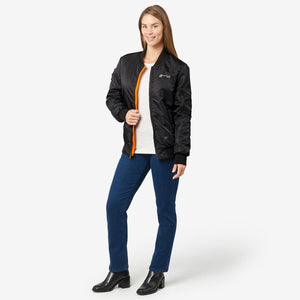 Black bomber jacket by Venture Heat with visible orange lining and logo, worn open over a white tee, jeans, and boots.