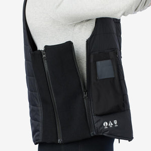 Black padded diving vest by Venture Heat, unzipped on a person to show ribbed side panels, internal pocket, and feature symbols.