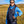Black padded waterproof diving vest by Venture Heat, featuring a logo, worn by a smiling woman over a blue hoodie outdoors.