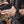 Black rugged wrist remote controller by Venture Heat, worn on a wrist and connected to a black power bank.