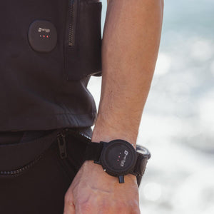 Black round wrist remote controller by Venture Heat with three red lights, worn on a person's wrist.