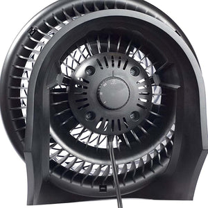 Black full-size whole room air circulator fan by Vornado, showing the front grille and central control dial from a side view.