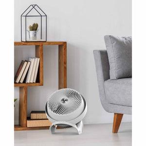 Polar white large air circulator by Vornado, with a distinctive spiral grille, on a light floor.